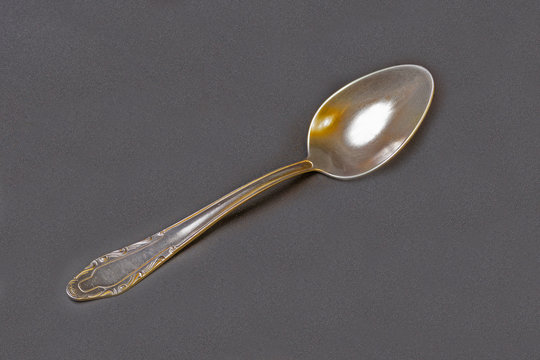 op view of an old stainless steel tablespoon close up