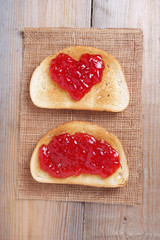 Heart shape jam on toasted bread