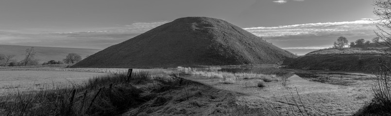 Silbury hill in Wiltshire England. Wintery image with frost on the ground.