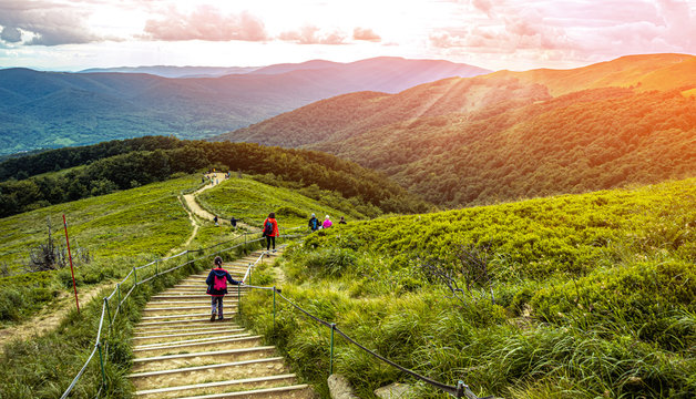 Child hiking in the mountains at sunset. BIeszczady Poland.