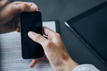 Business man sitting at the table phone tablet technology internet finance office