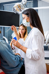 A female Dentist preparing to examine a Patient