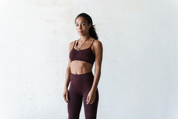 Photo of athletic african american woman standing while working out