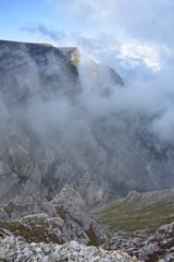 fluffy white clouds among the mountain ridges. mist at high altitude