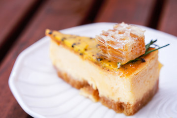 A piece of passion fruit cake with honeycomb on white plate.