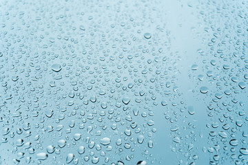 Macro raindrops vapor on window glass. Rain drops on window glasses surface. Through the window view. Drops of rain on glass. Water pattern texture
