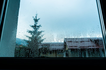Macro raindrops vapor on window glass. Rain drops on window glasses surface. Through the window view. Drops of rain on glass. Water pattern texture