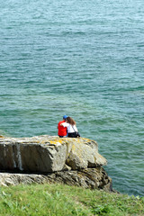 Couple on the ocean shore.Ireland.