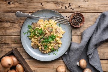 Scrambled eggs with mushrooms, onion and parsley