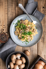 Scrambled eggs with mushrooms, onion and parsley