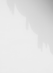 shadow of the curtain on the white wall