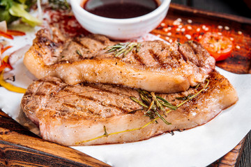 Closeup on grilled juicy steaks with rosemary 