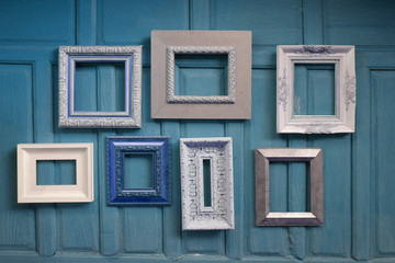 The frames for paintings on the wood wall.