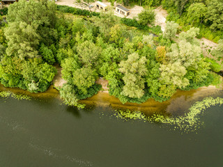Fototapeta na wymiar Aerial view. Green bank of the Dnieper river on a summer day.