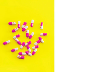 medical capsules with medication on a yellow background