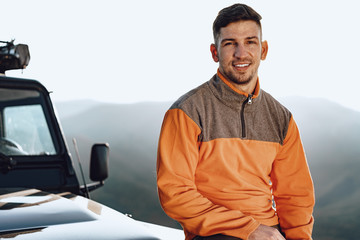 Portrait of a young caucasian man hiking in the mountains