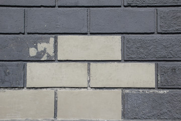 Old brick wall of black and white bricks. Close up. Wallaper. Background