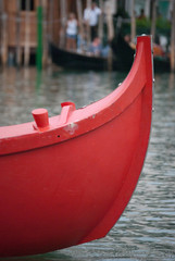 
bow of a red wooden boat in Venice