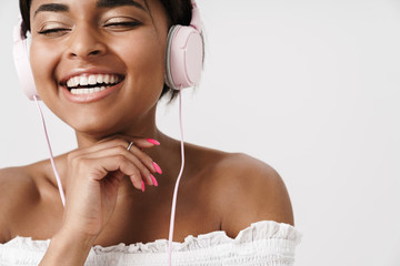 Image of african american woman listening to music with headphones