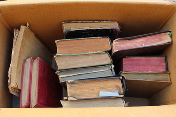Cardboard box with old books on the table close-up