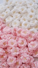 Artificial flowers made out of beautiful fabric texture in soft pink and broken white colors