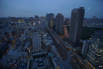 Naklejka na ściany i meble Modern business district with skyscrapers in Tokyo at night