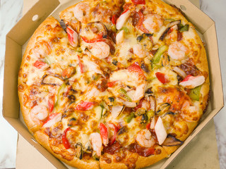 Seafood pizza in takeaway cardboard box