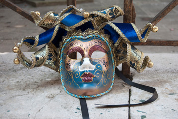 typical venetian carnival mask resting on the ground