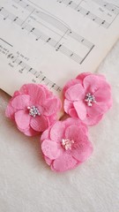 Artificial handmade flowers made out of beautiful lace fabric texture in pink color