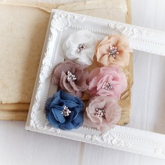 Fototapeta na wymiar Artificial handmade flowers made out of beautiful fabric texture in soft pastel colors
