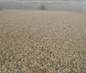 Fototapeta na wymiar Fine sand on the beach at a shore Mediterranean sea