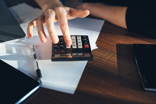 Workplace documents mobile phone laptop tablet coffee cup worker office.