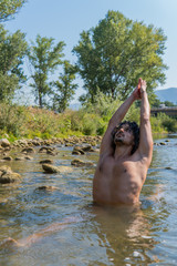Fototapeta na wymiar A man doing yoga in the middle of nature