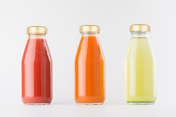 Tomato, carrot, green vegetable juices collection in glass bottles with cap in row mock up on white background, template for packaging, advertising, design product, branding.