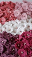 Artificial handmade flowers made out of beautiful fabric texture in pastel pink shades