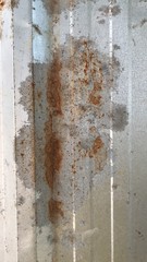 Rust on the iron fence plate background on the wall.