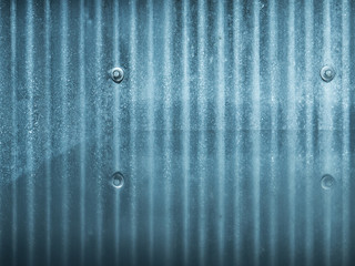 Blue metal corrugated background, with mirrored surface.  Detailed cold blue metal with nuts and bolts.