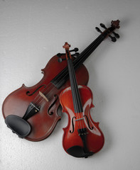Plakat Two violins put on background,show detail and different size of acoustic instrument