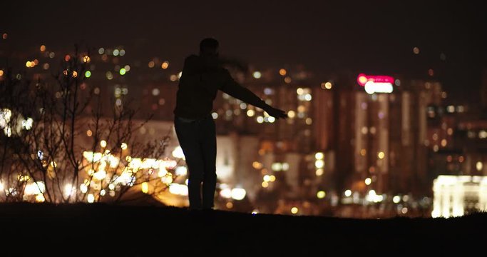 Male dancer above the city, slow motion