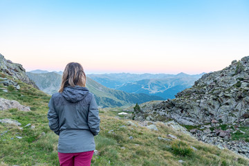 Naklejka na ściany i meble Woman in the Vall de Riu lake from the Estanyo peak in Andorra in summer 2020