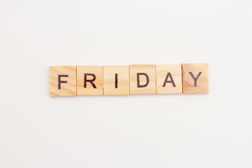 Word FRIDAY made from wooden cubes on white. Days of the week