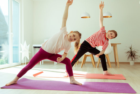 Happy Siblings Children Making Yoga At Home