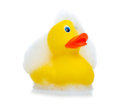Yellow rubber duck with foam on white background isolation