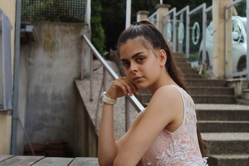 Fototapeta premium Young long-haired girl poses outside close-up