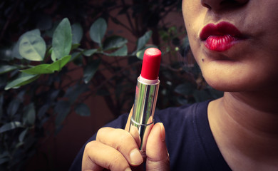 woman applying lipstick