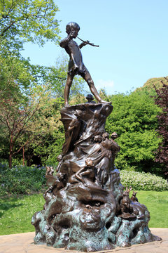 Peter Pan statue sculpture in Kensington Park Gardens London England UK unveiled in 1912 which is a popular travel destination tourist attraction landmark of the city centre stock photo