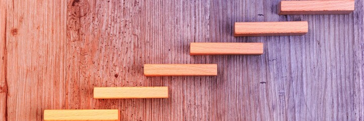 Wooden stairs symbolize growth. Step by step on colorful background