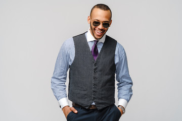Fototapeta premium Studio shot of young African-American businessmanman over grey background
