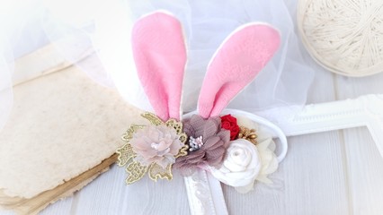 Handmade flowers as headband hair accessory with bunny or rabbit ears as decoration in soft pastel colors