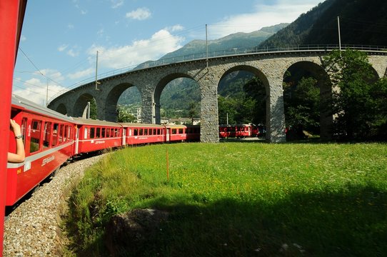 Switzerland - July 2012: Swiss Red Train Bernina Express pass on Brusio Viaduct, Italy & Switzerland.